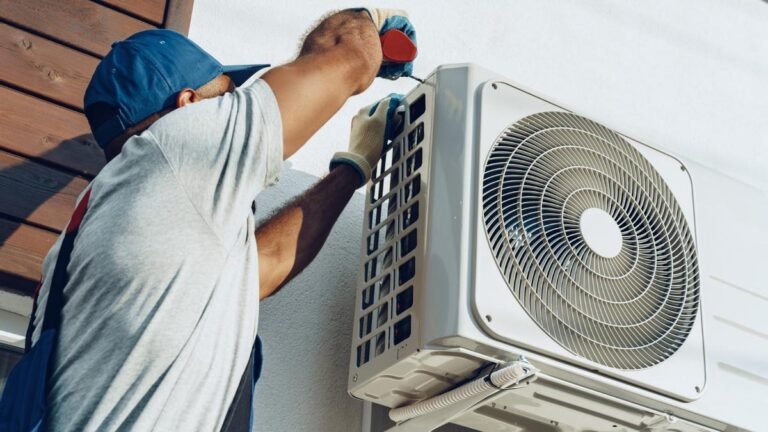 Técnico instalando una unidad exterior de aire acondicionado